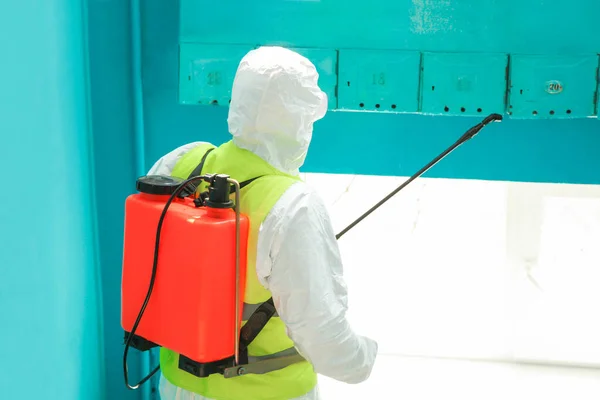 depositphotos_362944680-stock-photo-specialist-protective-suit-disinfects-entrance